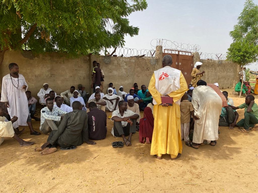 MSF teams are assessing the medical situation of newly arrived refugees in Adré seated in front of the fence.