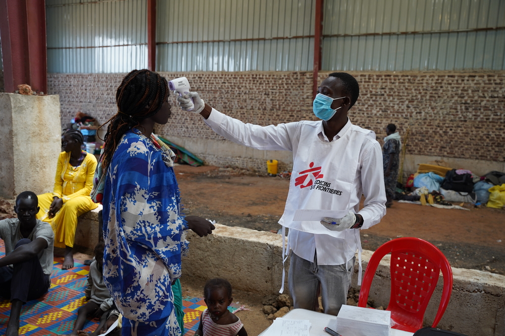 MSF nurse checking temperature of a patient at a mobile clinic in South Sudan.